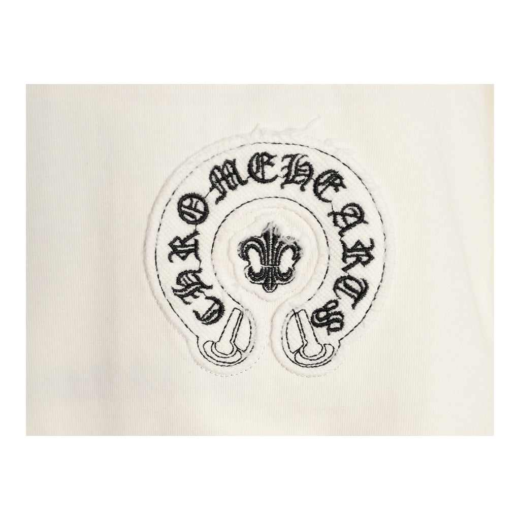 Chrome Hearts horseshoe fleur-de-lis chest embroidery detail on cream