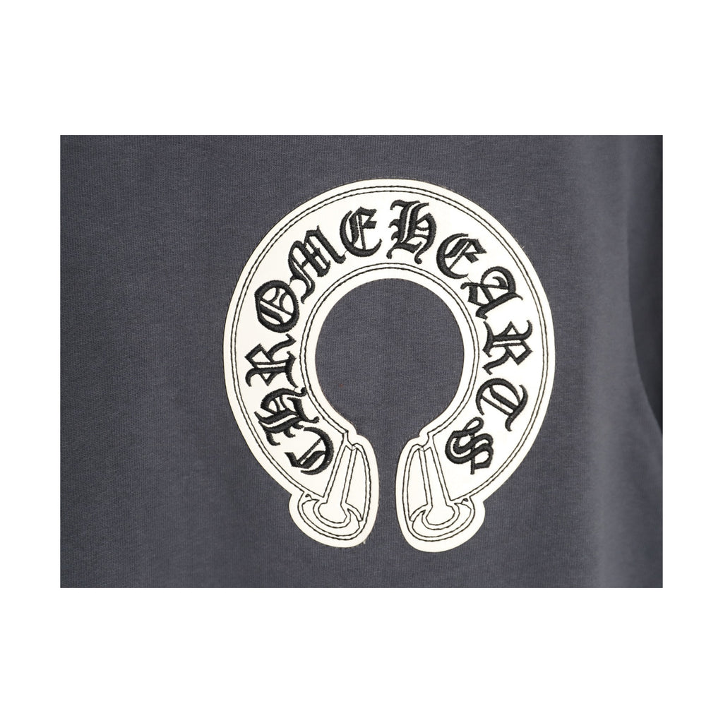 Chrome Hearts embroidered horseshoe chest emblem detail on charcoal
