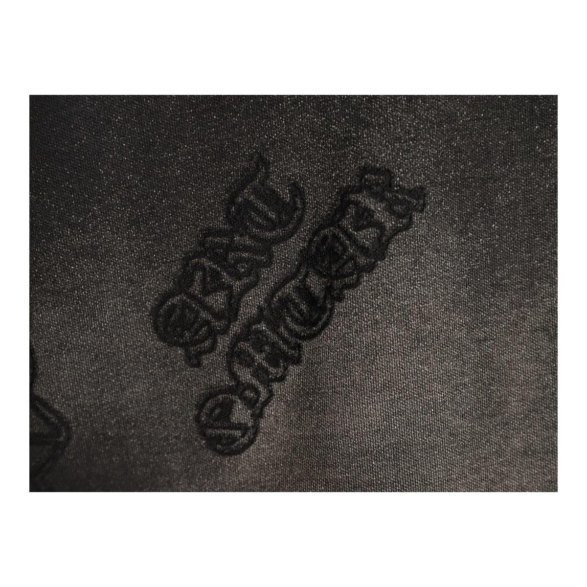 Chrome Hearts Gothic script laser-burn detail on black