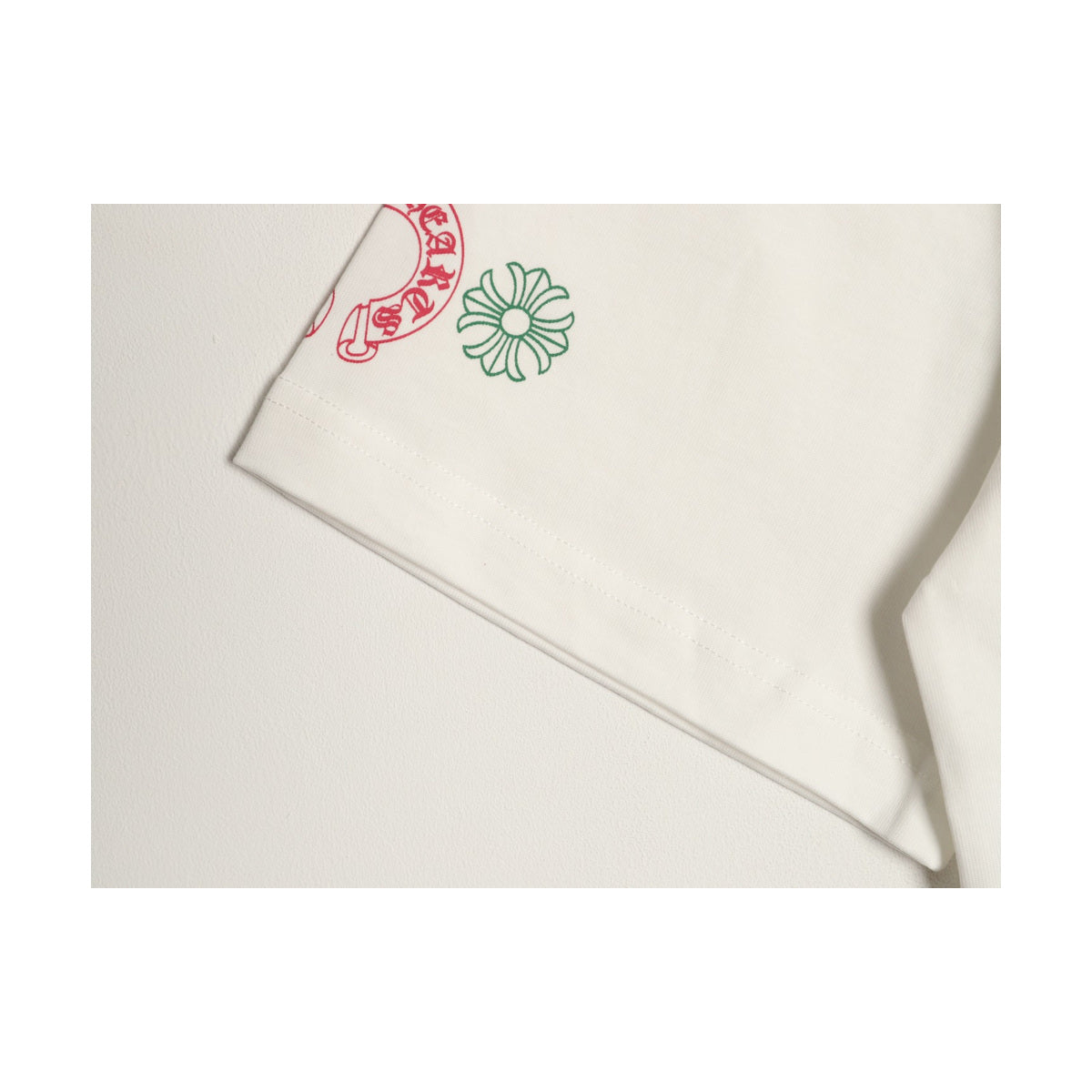 Chrome Hearts cream sleeve emblem and fabric detail